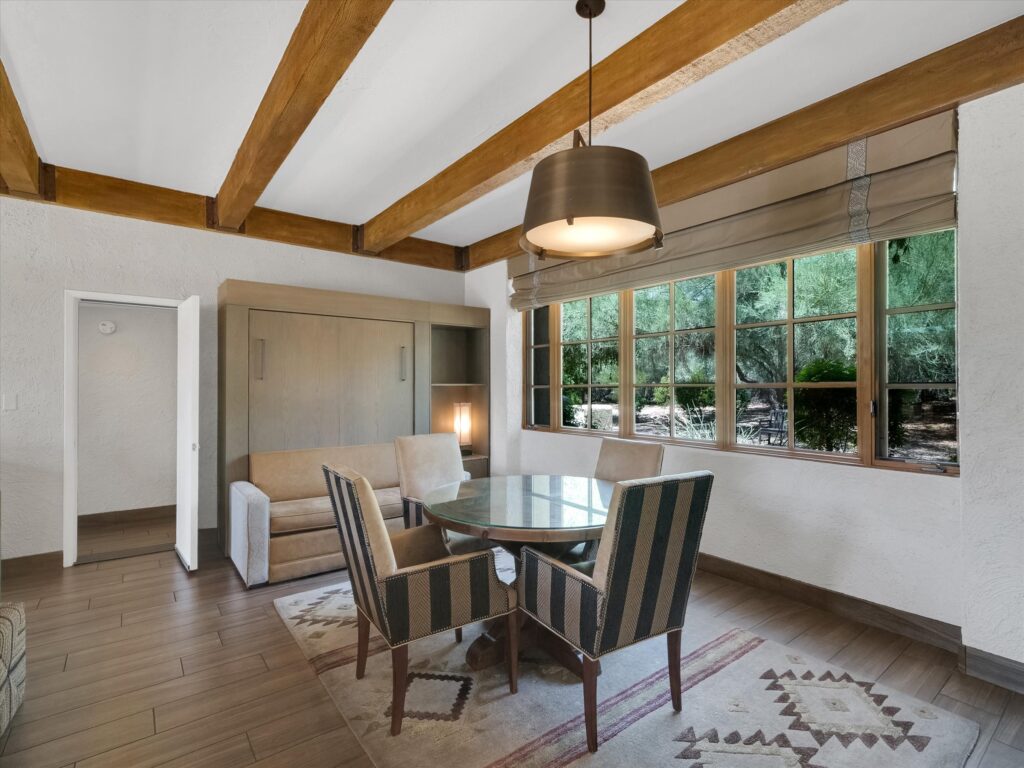 Dining nook in Camelback Inn Unit 569 with Murphy bed, seating area, and large windows