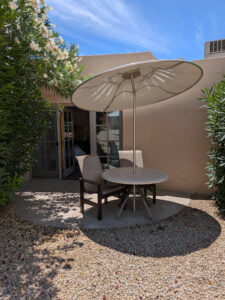 Enjoy outdoor living from the private patio of Unit 144, featuring comfortable seating surrounded by mature desert landscaping in the quiet Tennis/Kiva area of the JW Marriott Camelback Inn Resort.