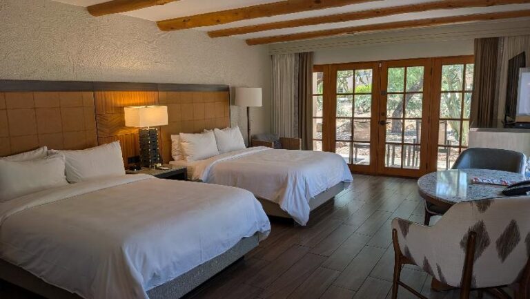 Two-bed resort casita with vaulted wood-beamed ceiling and large windows in Unit 460 at the JW Marriott Camelback Inn Resort in Scottsdale, Arizona.