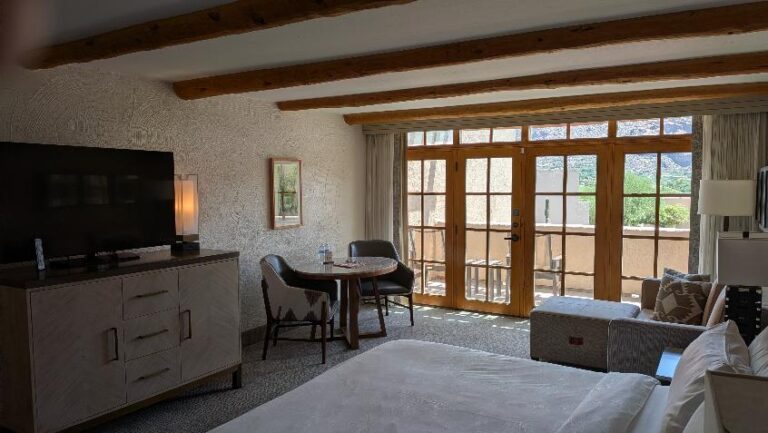 Bright furnished resort casita interior with bed, sitting area and large windows in Unit 481 at the JW Marriott Camelback Inn Resort in Scottsdale, Arizona.
