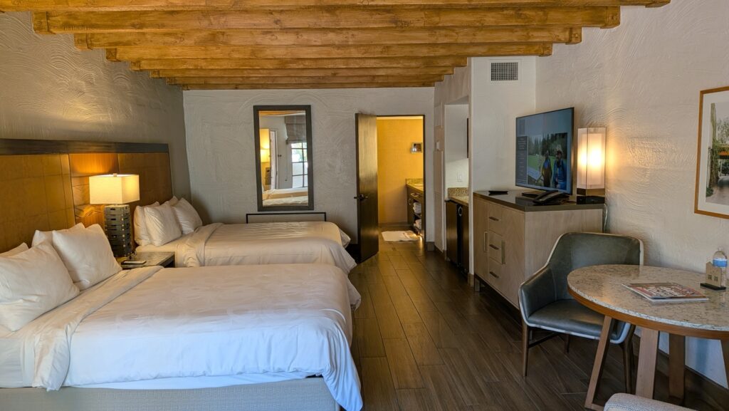 Unit 317 for sale at JW Marriott Scottsdale Camelback Inn Resort & Spa with two beds, sleeper sofa and wood-beamed ceiling