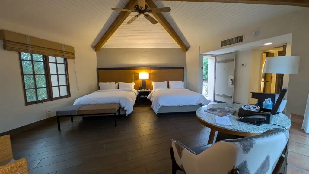Camelback Inn Unit 279 for sale in Scottsdale, Arizona, featuring two beds, vaulted wood-beamed ceilings, and spacious resort accommodations.