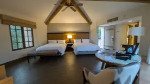 Camelback Inn Unit 279 for sale in Scottsdale, Arizona, featuring two beds, vaulted wood-beamed ceilings, and spacious resort accommodations.